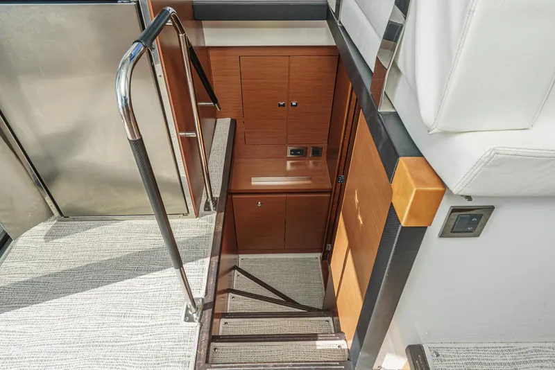 Slide: The Image of Staircase in 2015 Prestige 420 yacht interior with wooden paneling and metal railing. - 27