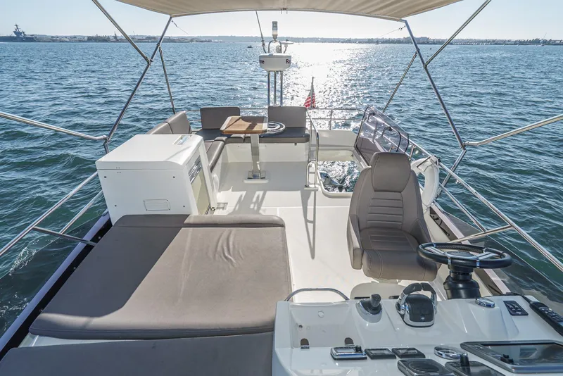 Slide: The Image of Prestige 420 yacht interior, 2015 model, featuring spacious deck and seating area on open water. - 8