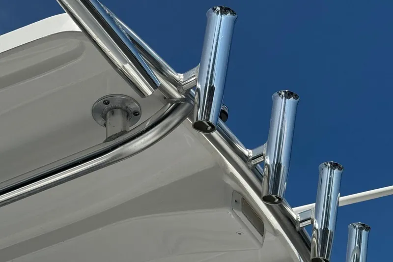Slide: The Image of Cape Horn 22 OS 2022 boat with chrome rod holders against blue sky. - 8