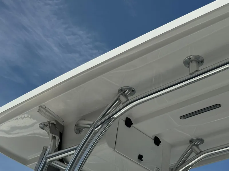 Slide: The Image of Close-up of 2022 Cape Horn 22 OS boat's T-top and stainless steel supports against blue sky. - 2
