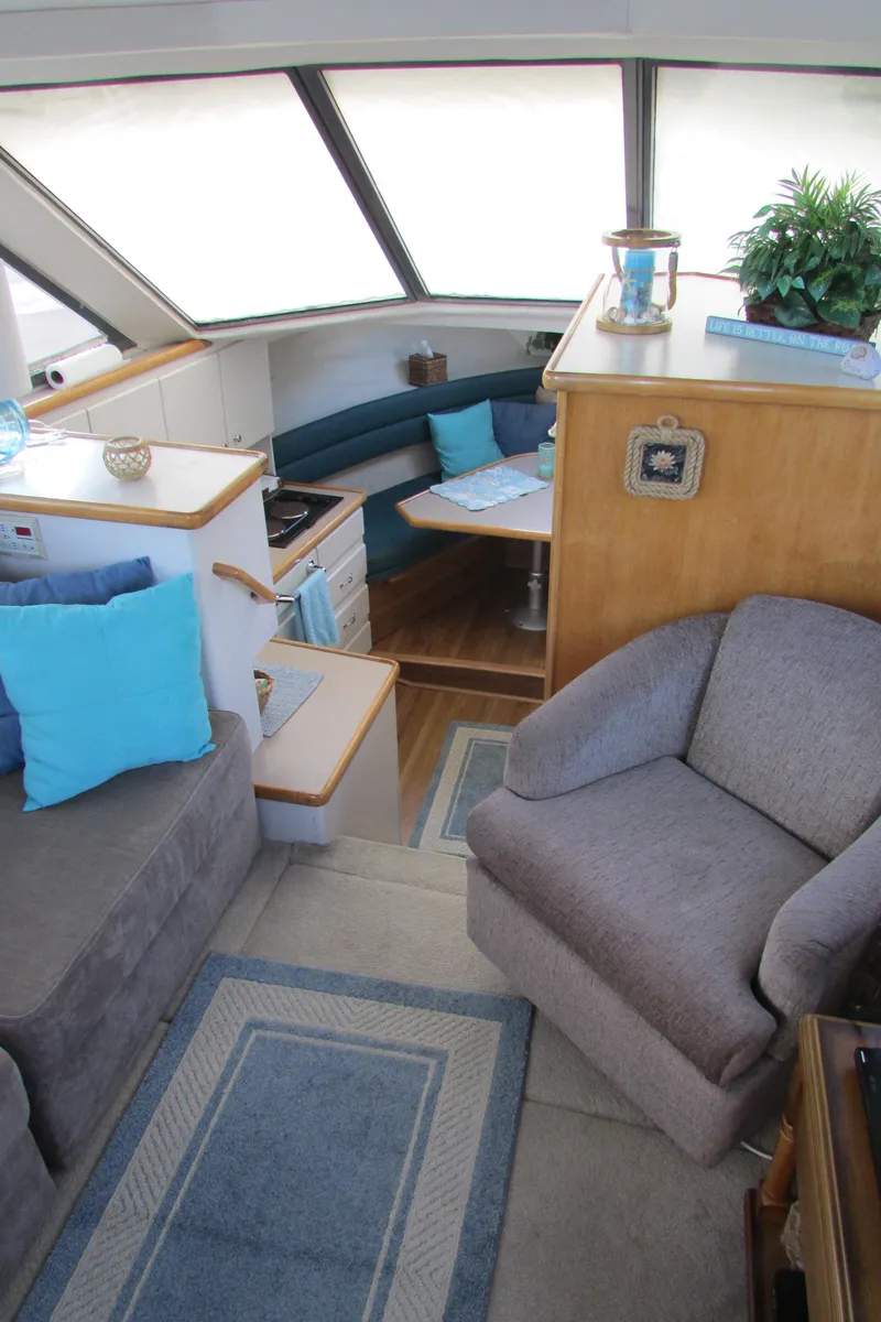 Slide: The Image of Interior of 1995 Carver 325 Aft Cabin with cozy seating and dining area. - 15