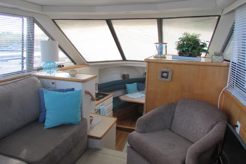 Slide: The Image of Interior of 1995 Carver 325 Aft Cabin yacht with cozy seating and decor. - 16