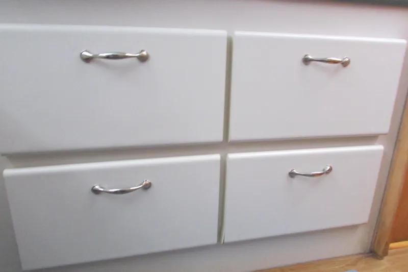 Slide: The Image of White cabinet drawers with silver handles in a 1995 Carver 325 Aft Cabin. - 20