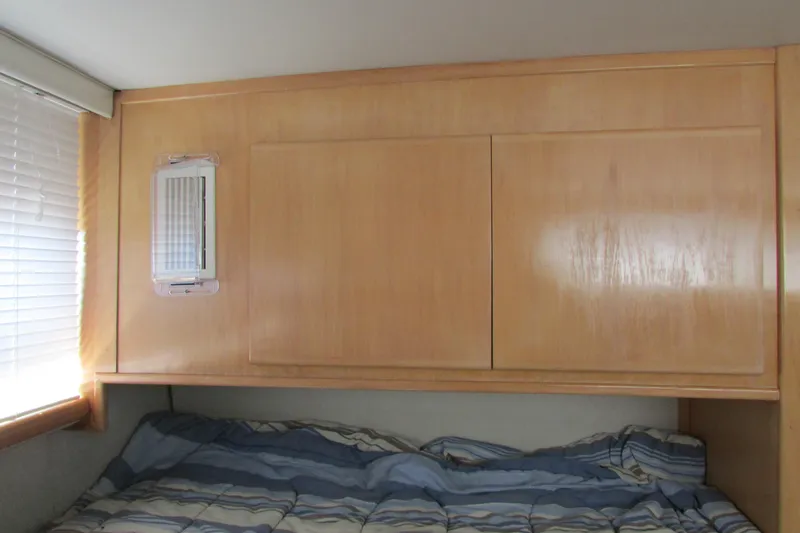 Slide: The Image of 1995 Carver 325 Aft Cabin interior with wooden paneling and bed. - 21