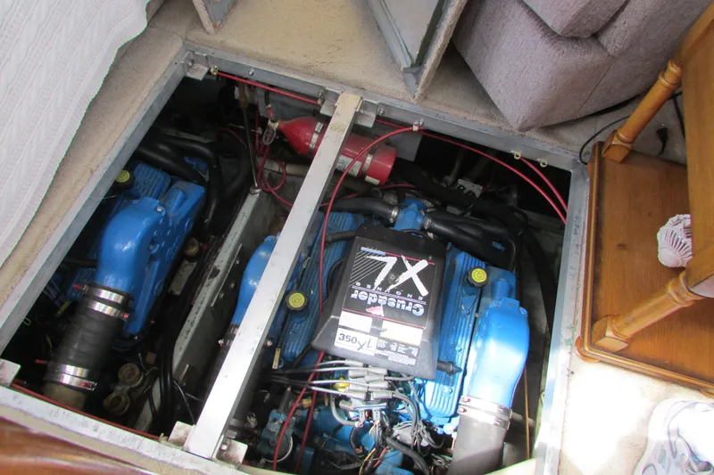 Slide: The Image of Engine compartment of a 1995 Carver 325 Aft Cabin boat, showcasing dual blue engines. - 29