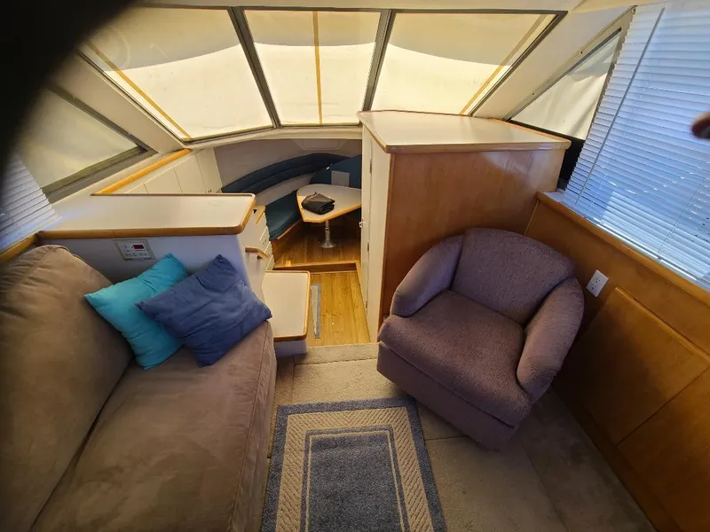Slide: The Image of Interior of 1995 Carver 325 Aft Cabin with cozy seating and natural light. - 36
