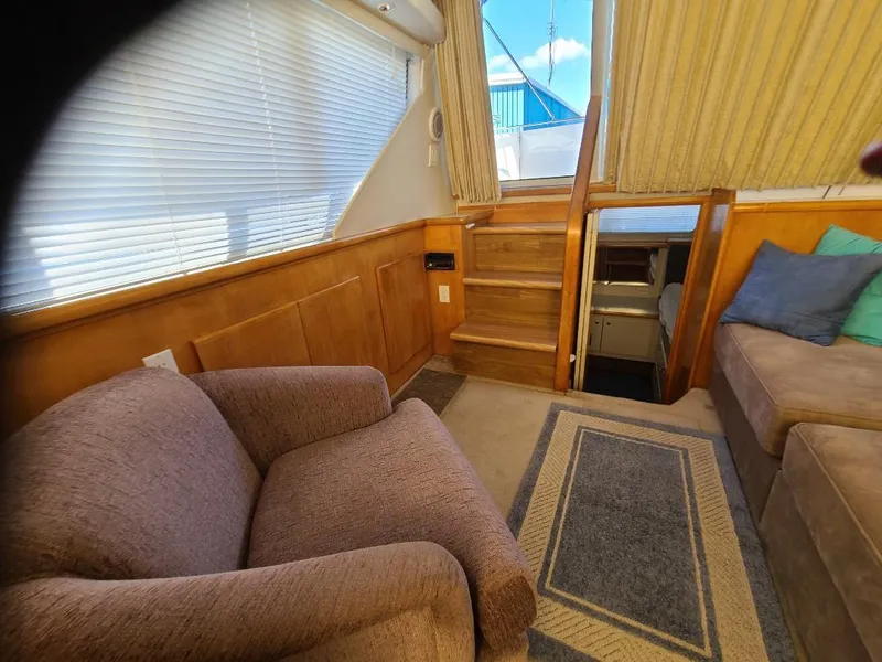 Slide: The Image of Interior of 1995 Carver 325 Aft Cabin with cozy seating and wooden accents. - 38