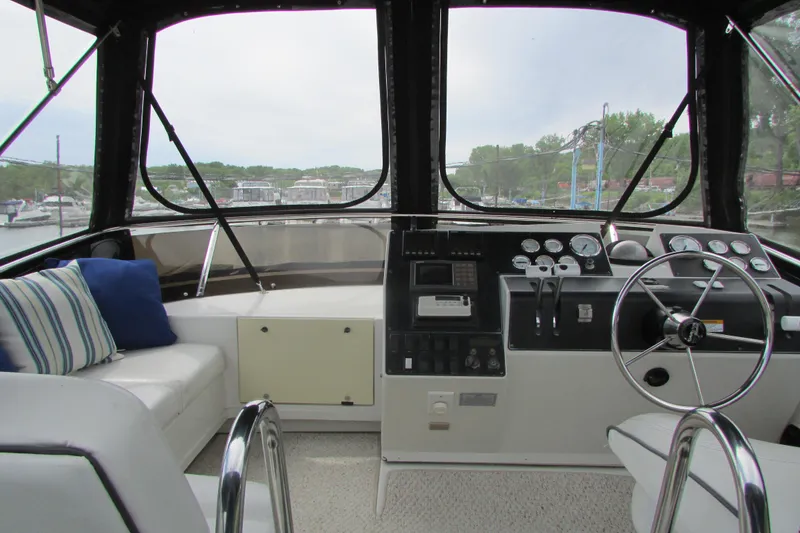 Slide: The Image of Interior view of 1995 Carver 325 Aft Cabin yacht helm with seating and controls. - 5