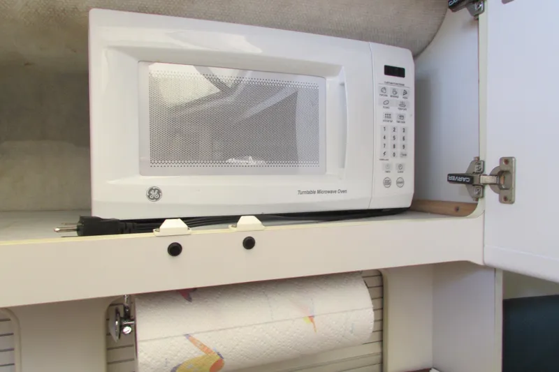 Slide: The Image of Microwave in 1995 Carver 325 Aft Cabin kitchen with paper towel holder. - 11