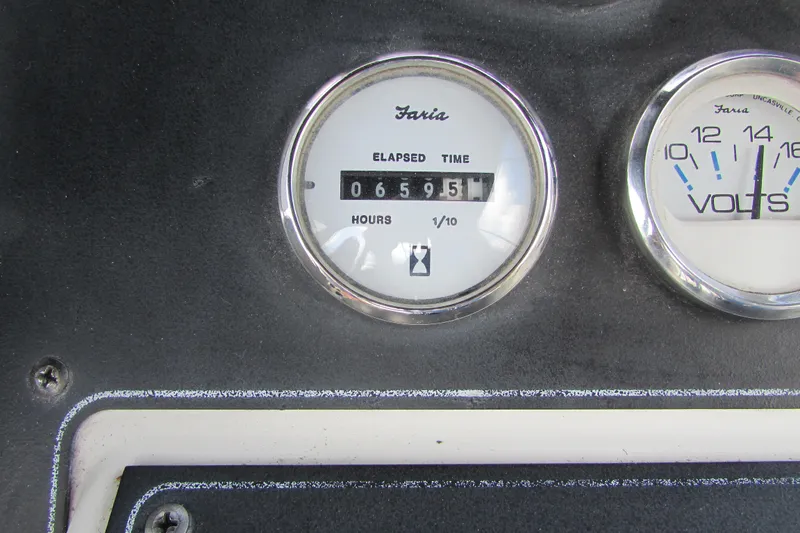 Slide: The Image of 1995 Carver 325 Aft Cabin dashboard with elapsed time and voltage gauges. - 28