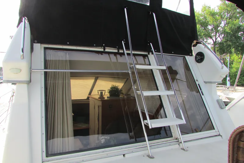 Slide: The Image of 1995 Carver 325 Aft Cabin yacht with ladder and window view. - 3