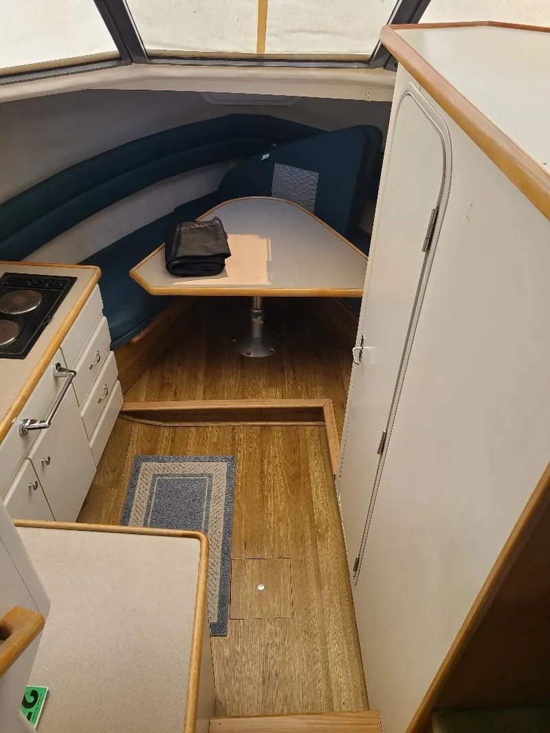 Slide: The Image of Interior of 1995 Carver 325 Aft Cabin with kitchenette and dining area. - 32