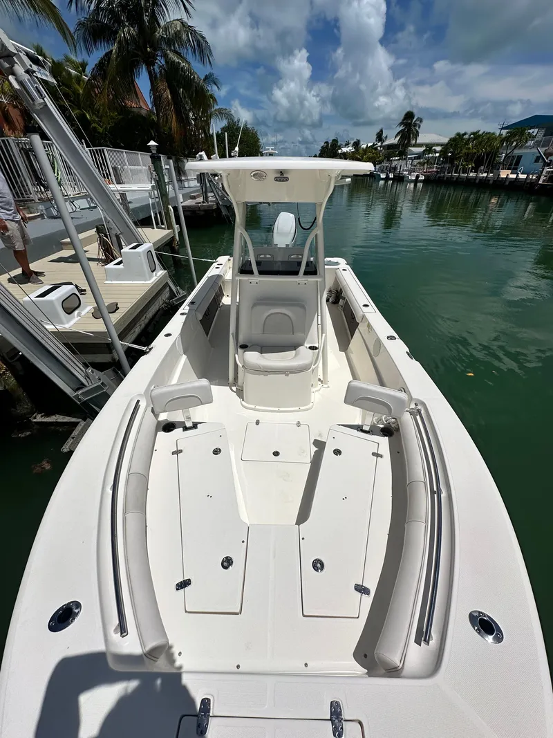 Slide: The Image of 2023 Sea Born LX24 boat docked in a scenic marina setting. - 10