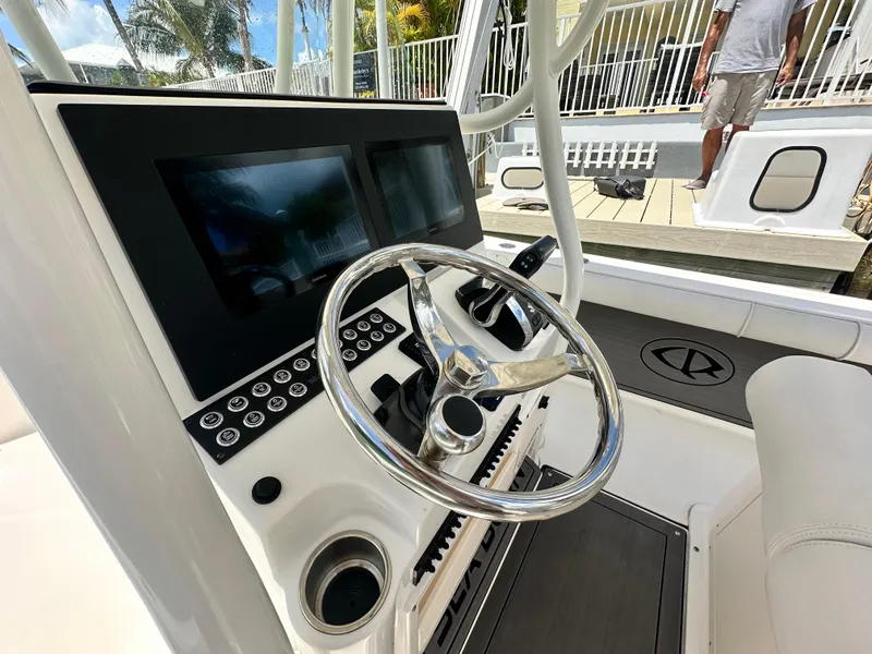 Slide: The Image of 2023 Sea Born LX24 boat dashboard with dual screens and steering wheel. - 14
