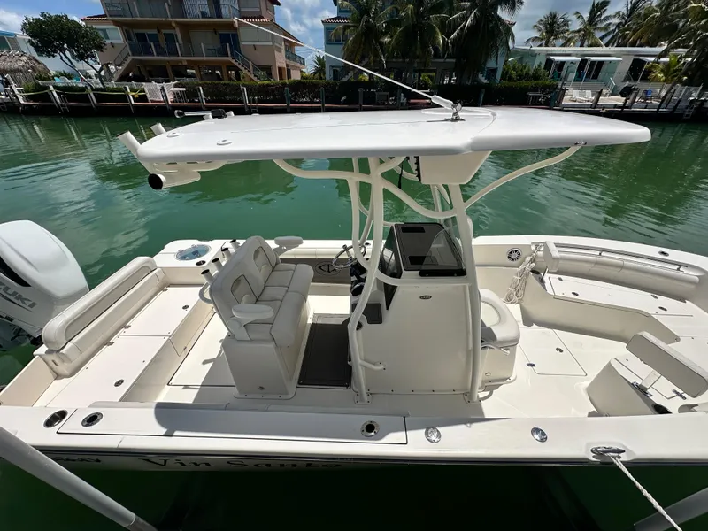 Slide: The Image of 2023 Sea Born LX24 boat docked in a tropical marina setting. - 19