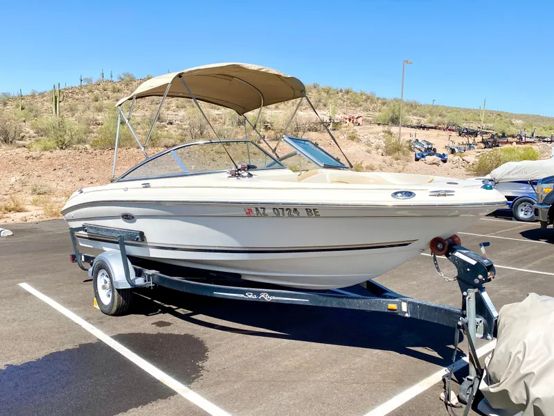 The Image of 2001 Sea Ray 185 Bow Rider parked on trailer outdoors. - 1
