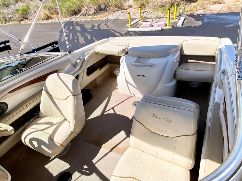 Slide: The Image of Interior of a 2001 Sea Ray 185 Bow Rider boat with beige seating. - 14