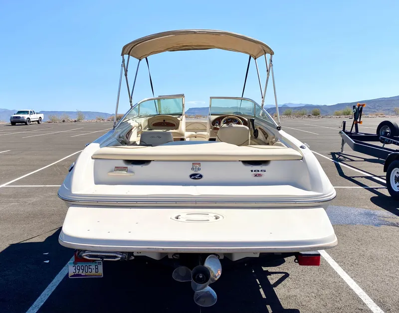 Slide: The Image of Rear view of a 2001 Sea Ray 185 Bow Rider boat in a parking lot. - 3