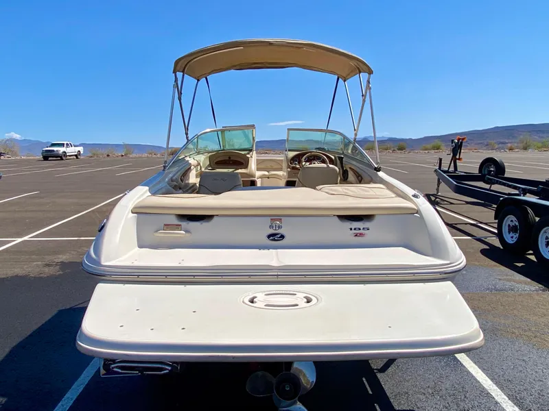 Slide: The Image of 2001 Sea Ray 185 Bow Rider boat in parking lot. - 8