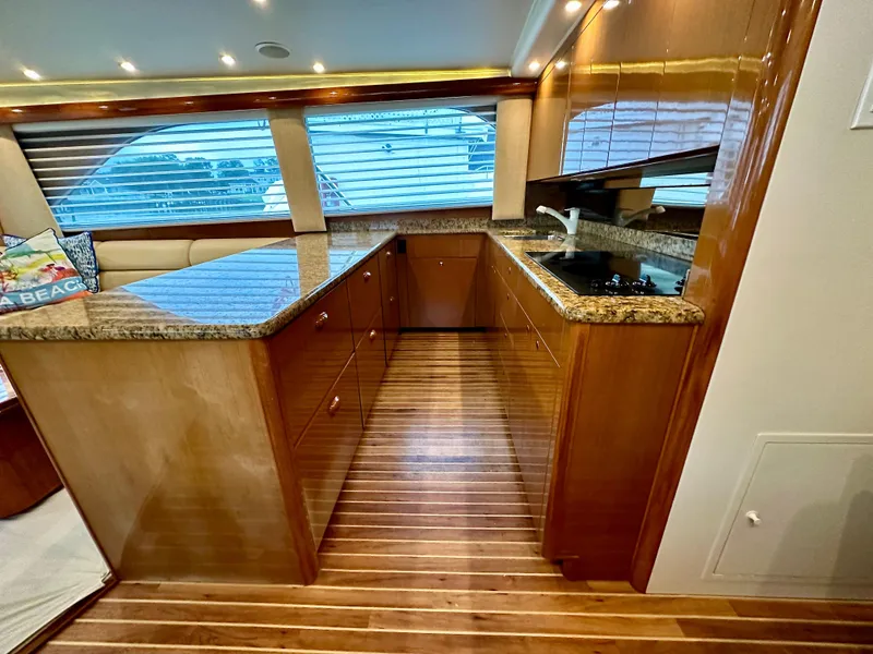 Slide: The Image of Luxurious kitchen interior of 2004 Viking 56 Convertible SONAR yacht with wood flooring. - 13