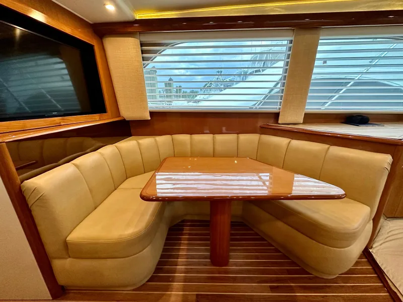 Slide: The Image of Luxurious interior of 2004 Viking 56 Convertible SONAR yacht with plush seating and wooden table. - 16