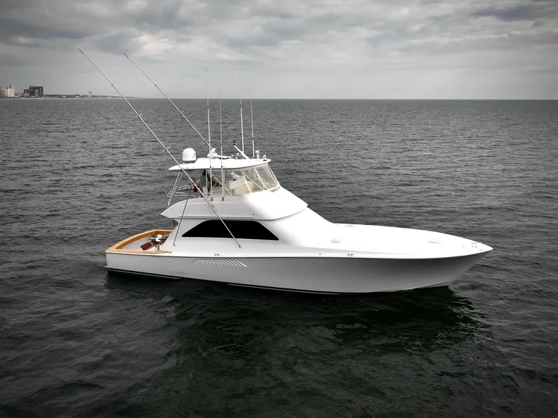Slide: The Image of 2004 Viking 56 Convertible SONAR yacht on open sea under cloudy sky. - 2