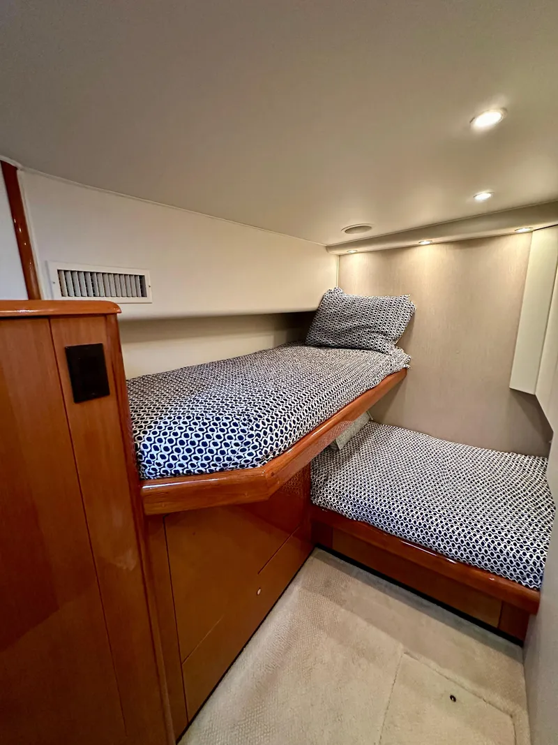 Slide: The Image of Cozy twin bunk beds in 2004 Viking 56 Convertible SONAR yacht cabin. - 20