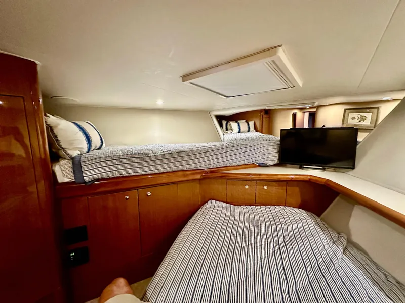 Slide: The Image of Cozy cabin interior of 2004 Viking 56 Convertible SONAR with twin beds and TV. - 21
