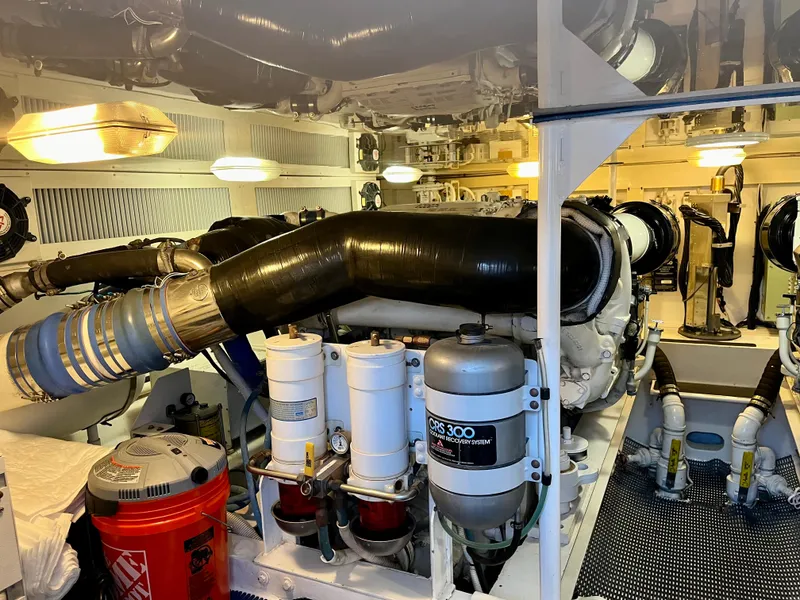 Slide: The Image of Engine room of 2004 Viking 56 Convertible SONAR yacht, featuring complex machinery and piping. - 31
