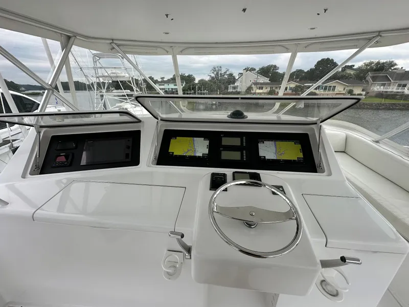Slide: The Image of Viking 56 Convertible SONAR 2004 yacht helm with navigation screens and steering wheel. - 7