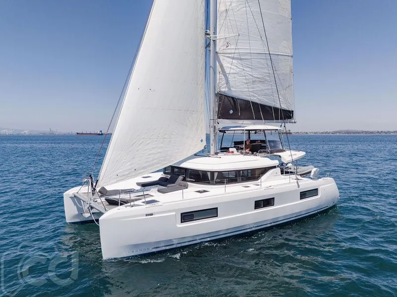 Slide: The Image of 2021 Lagoon 46 catamaran sailing on open water under clear blue skies. - 12