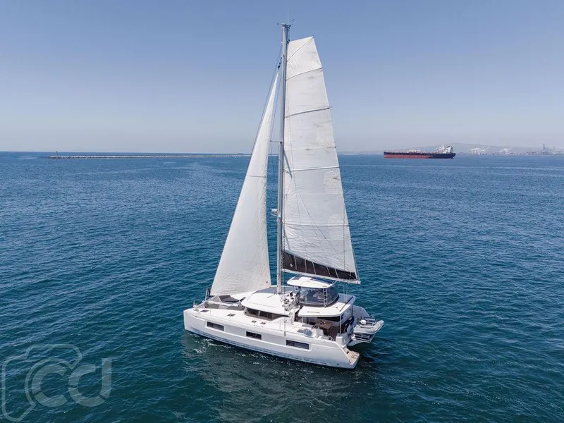 Slide: The Image of Sailing catamaran Lagoon 46 (2021) on open sea with clear skies. - 13