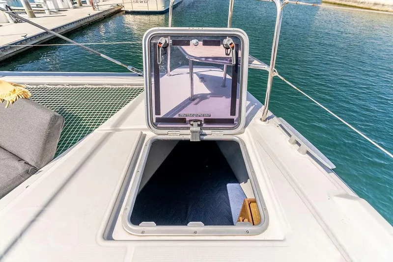 Slide: The Image of Open hatch on 2021 Lagoon 46 catamaran deck, overlooking marina waters. - 19
