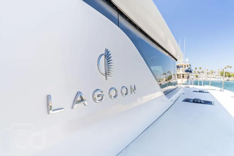 Slide: The Image of 2021 Lagoon 46 yacht, sleek design, docked in sunny marina. - 20