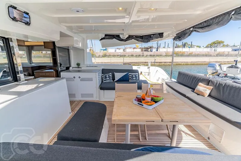 Slide: The Image of Luxurious Lagoon 46 catamaran interior, 2021 model, featuring elegant seating and dining area. - 22