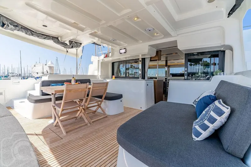 Slide: The Image of Spacious deck of 2021 Lagoon 46 catamaran with seating and dining area. - 23