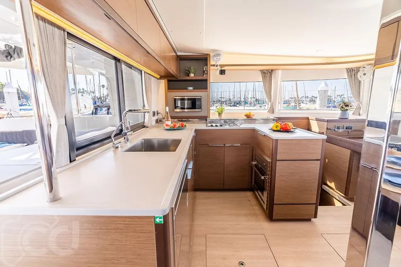 Slide: The Image of Modern kitchen interior of 2021 Lagoon 46 catamaran with sleek countertops and ample natural light. - 27