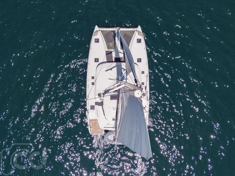Slide: The Image of Aerial view of 2021 Lagoon 46 catamaran sailing on sparkling blue water. - 3