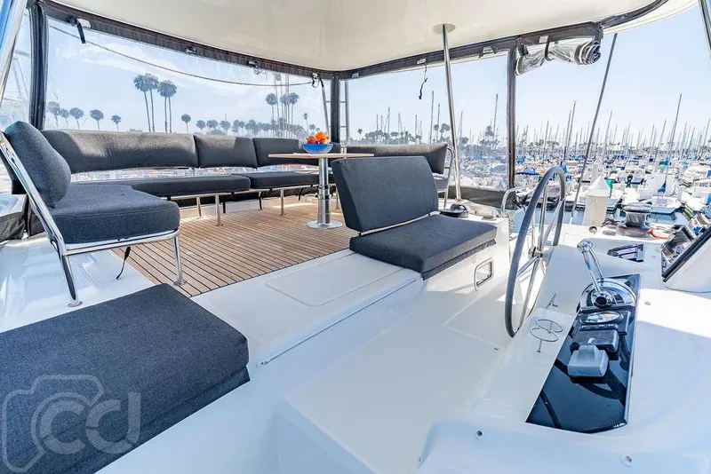 Slide: The Image of Luxurious 2021 Lagoon 46 yacht interior with modern seating and marina view. - 31
