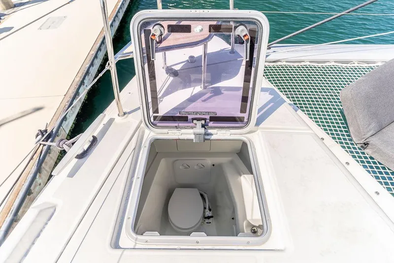 Slide: The Image of Hatch on Lagoon 46 catamaran deck revealing a compact marine toilet. - 34