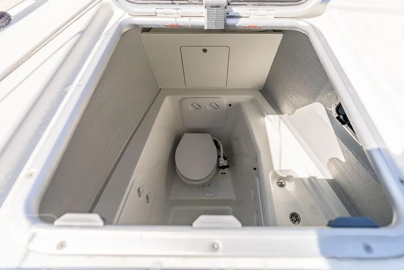 Slide: The Image of 2021 Lagoon 46 yacht bathroom compartment with compact toilet and storage space. - 35
