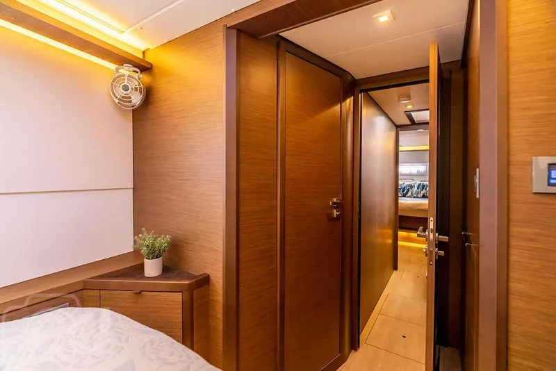 Slide: The Image of Luxurious interior of 2021 Lagoon 46 yacht, featuring wood paneling and modern design. - 37