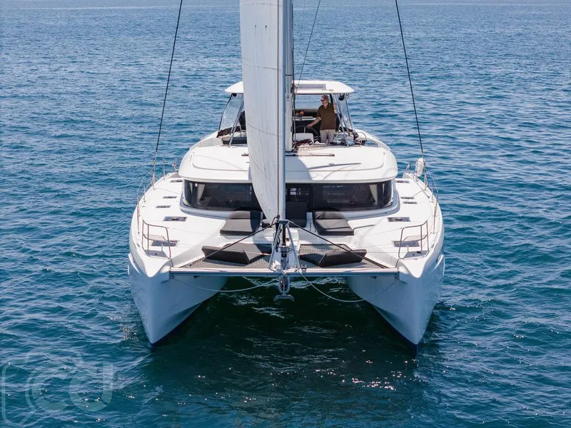 Slide: The Image of 2021 Lagoon 46 catamaran sailing on open sea, front view. - 4