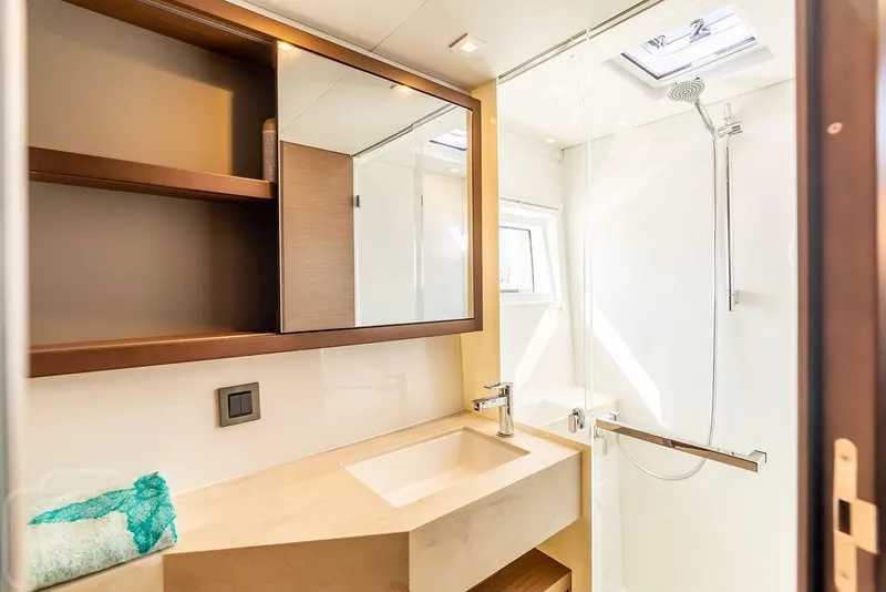 Slide: The Image of Modern bathroom in 2021 Lagoon 46 yacht with sleek sink, shower, and storage shelves. - 43