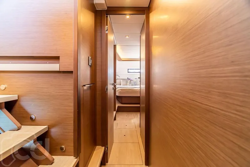 Slide: The Image of Interior hallway of 2021 Lagoon 46 yacht, featuring wooden paneling and modern design. - 44