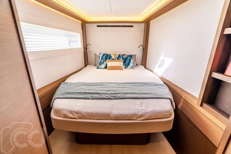 Slide: The Image of Luxurious bedroom interior of 2021 Lagoon 46 yacht with modern design and cozy bedding. - 46