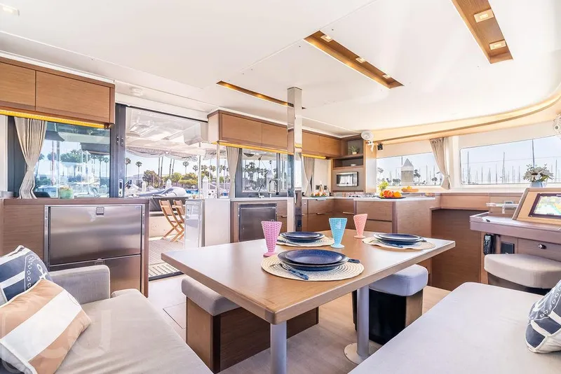 Slide: The Image of Luxurious interior of 2021 Lagoon 46 catamaran with modern dining area and scenic marina view. - 49