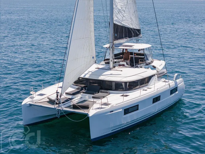 Slide: The Image of 2021 Lagoon 46 catamaran sailing on open sea, featuring sleek design and spacious deck. - 6