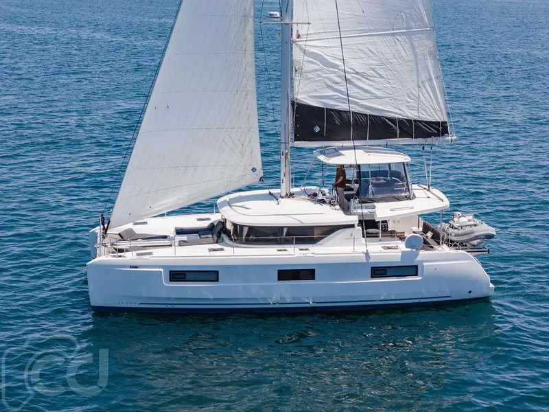 Slide: The Image of 2021 Lagoon 46 catamaran sailing on open water, showcasing sleek design and spacious deck. - 7