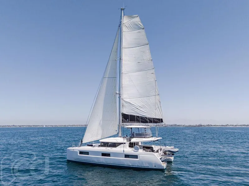 Slide: The Image of 2021 Lagoon 46 catamaran sailing on open water under clear skies. - 9